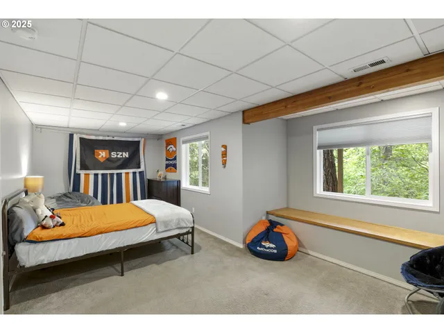 a room with pool table and windows