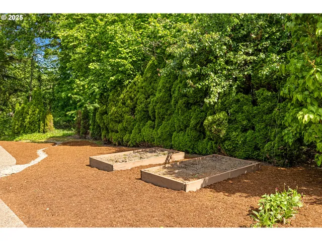 a front view of a house with a yard and fountain in middle of green field