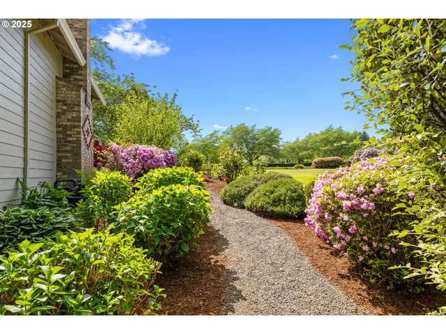 a view of a house with potted plants and a table and chairs