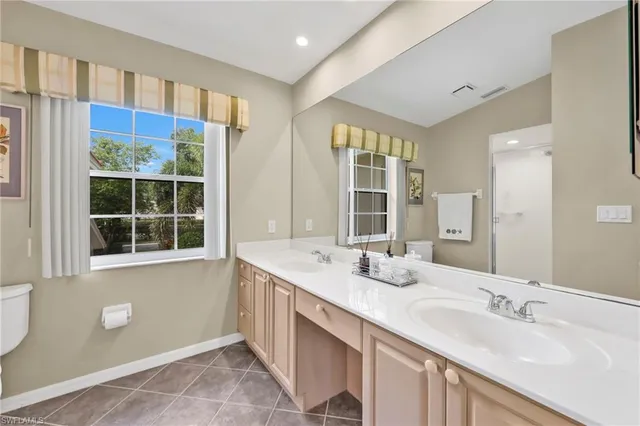 a bathroom with a sink double vanity and a mirror