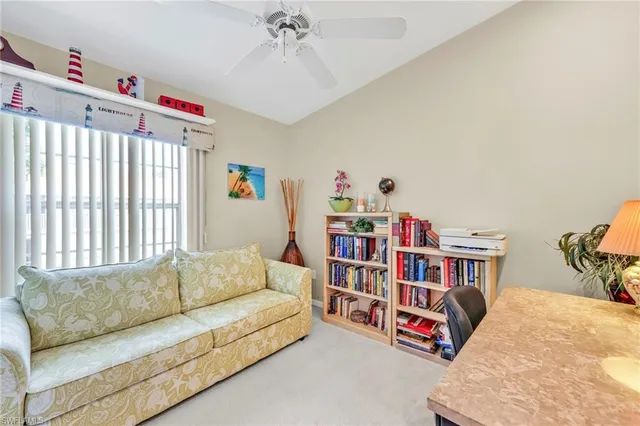 a living room with furniture and a book shelf