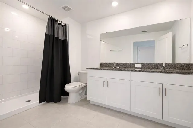 an empty room with a window and ceiling fan