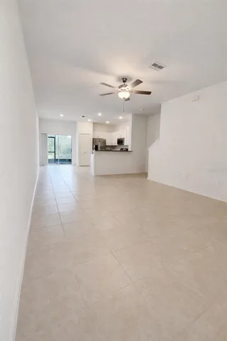 a view of a kitchen with furniture and a ceiling fan