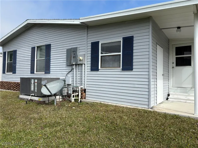 a view of a house with a yard and sitting area