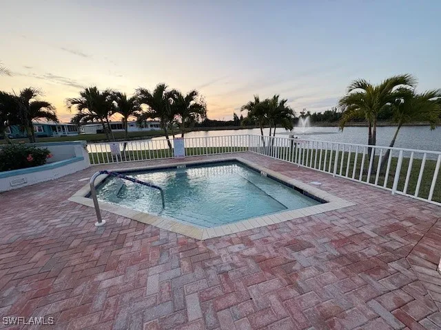 a view of a swimming pool with a lounge chair