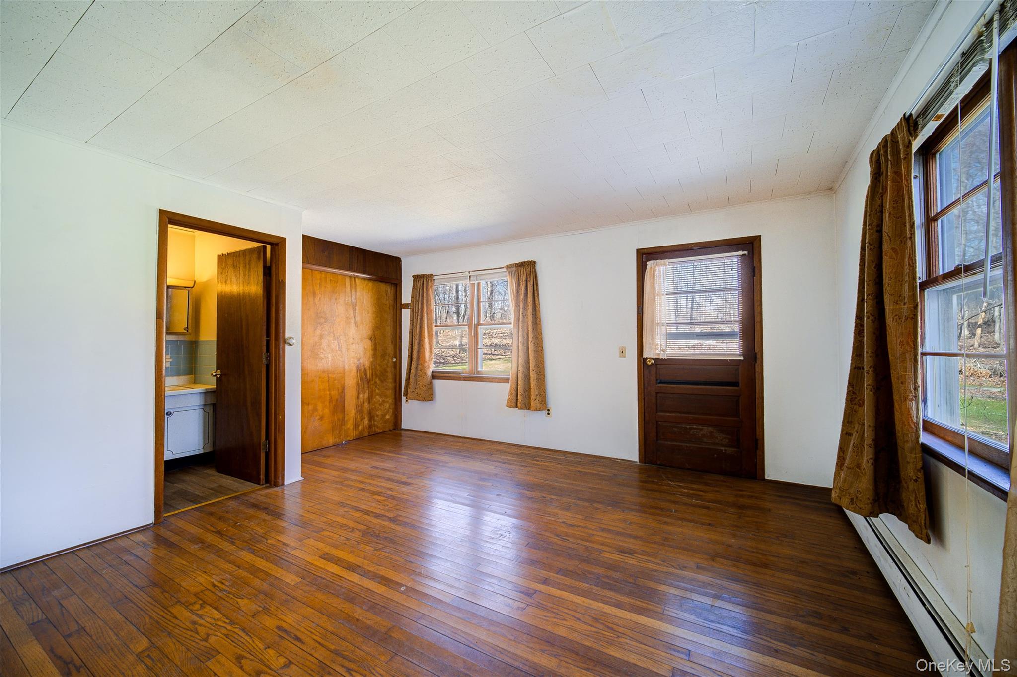 166 Brookside Farms Road Newburgh, NY 12550 - Photo 15 of 45 a view of an empty room with wooden floor and a window