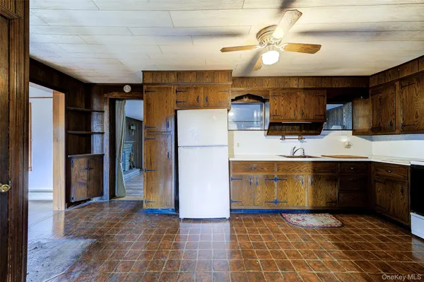 a kitchen with a refrigerator a sink and a stove