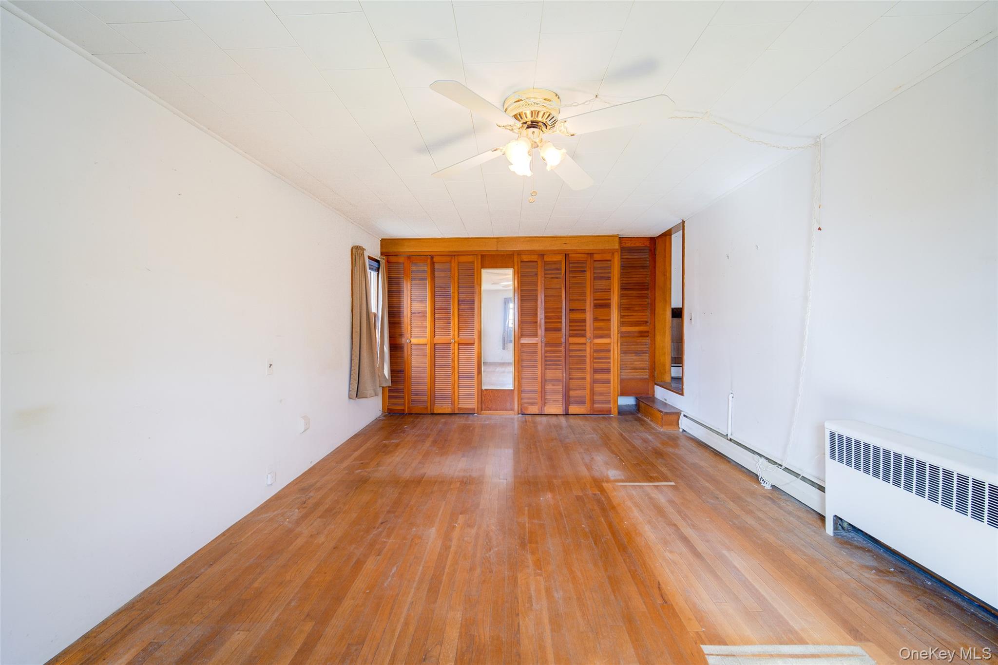 166 Brookside Farms Road Newburgh, NY 12550 - Photo 31 of 45 wooden floor in an empty room with a window