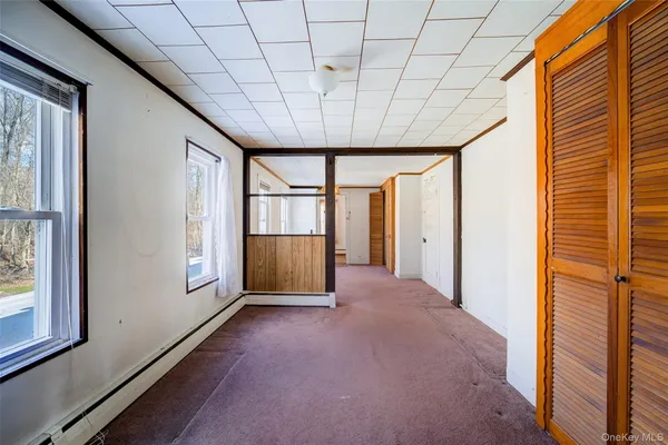 a view of livingroom with an empty room and window