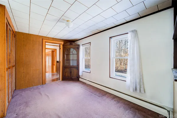 a view of a hallway with bathroom and front door