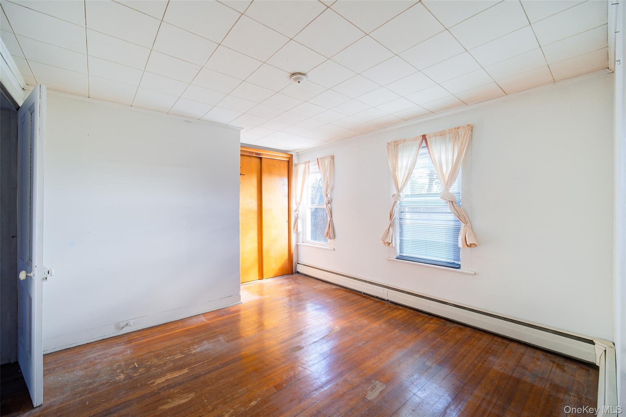 166 Brookside Farms Road Newburgh, NY 12550 - Photo 37 of 45 an empty room with wooden floor and windows