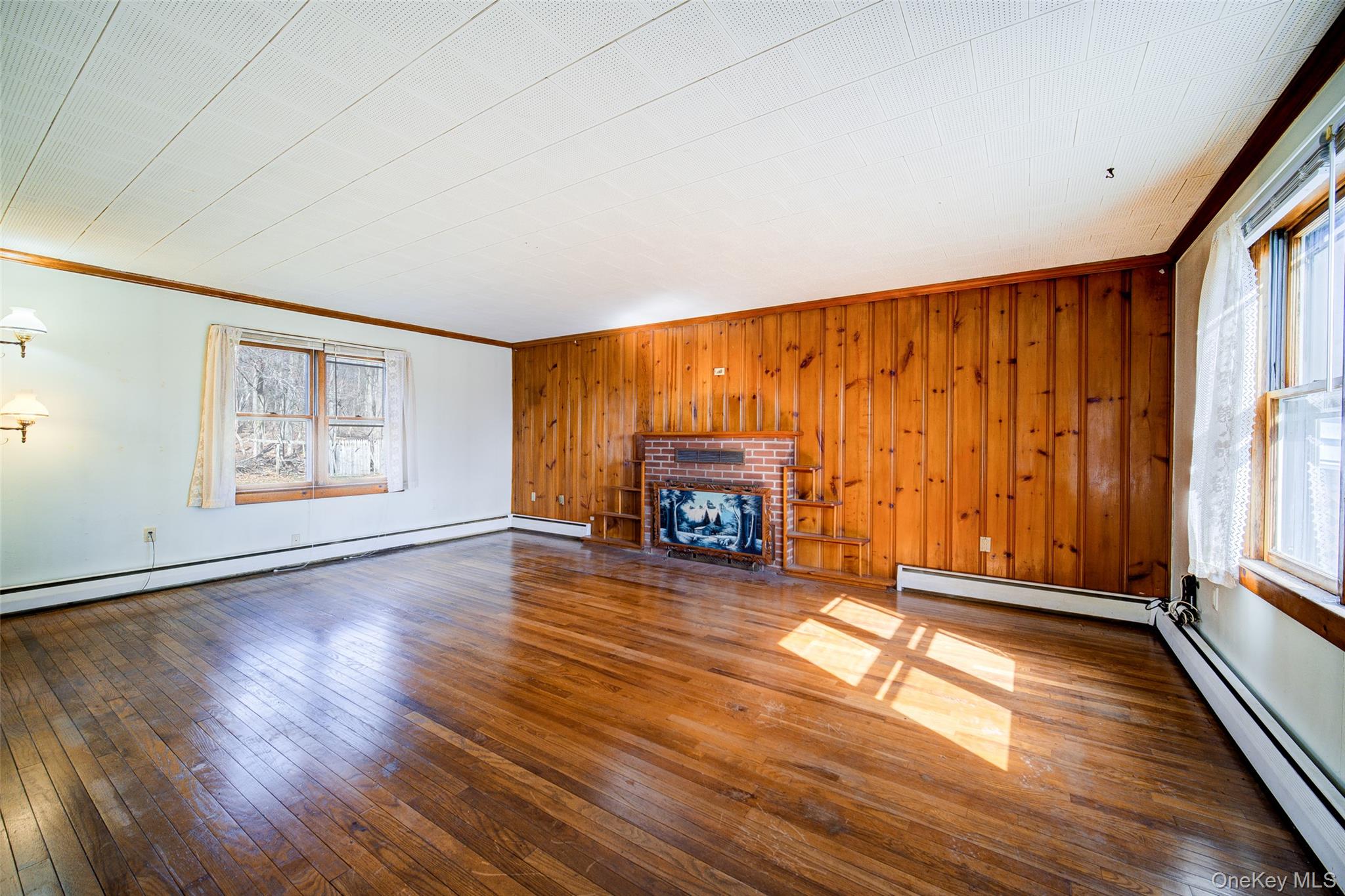 166 Brookside Farms Road Newburgh, NY 12550 - Photo 9 of 45 a view of an empty room with a window and wooden floor