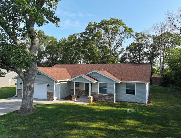 a aerial view of a house with swimming pool next to a yard