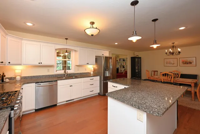 a kitchen with stainless steel appliances granite countertop stove top oven a sink and dishwasher