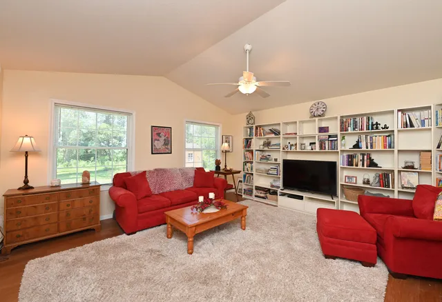 a living room with furniture a fireplace and a large window