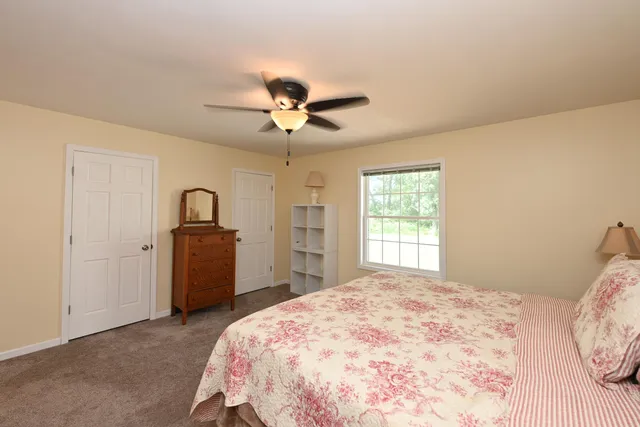 a bedroom with a large bed and a chandelier