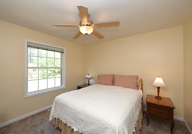 a bedroom with a bed and a lamp