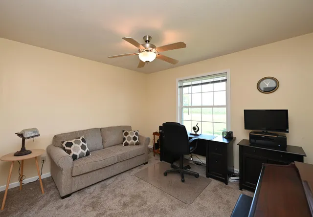 a living room with furniture and a flat screen tv with wooden floor