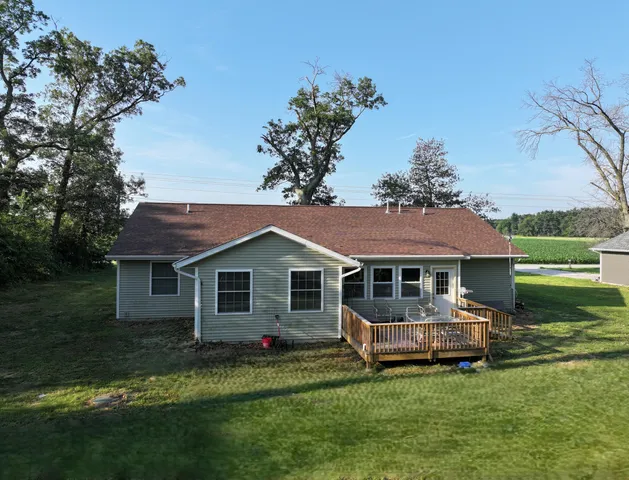 a front view of a house with a garden and trees