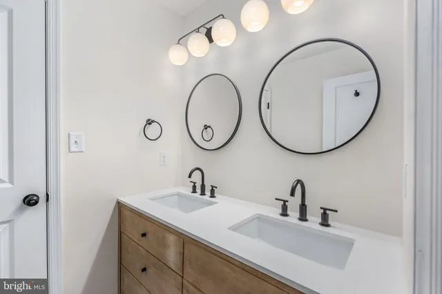 a bedroom with a bed mirror and window