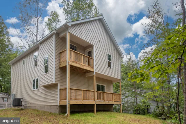 a large kitchen with kitchen island a large counter space a sink stainless steel appliances and cabinets