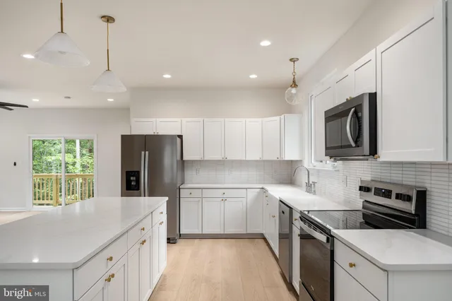 a kitchen with a refrigerator sink and cabinets