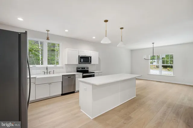 a bathroom with a granite countertop sink a shower and a mirror