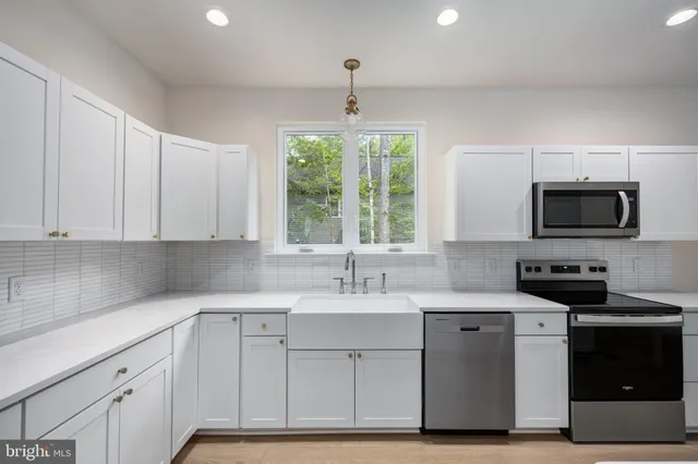 a bathroom with a sink a toilet a mirror and shower