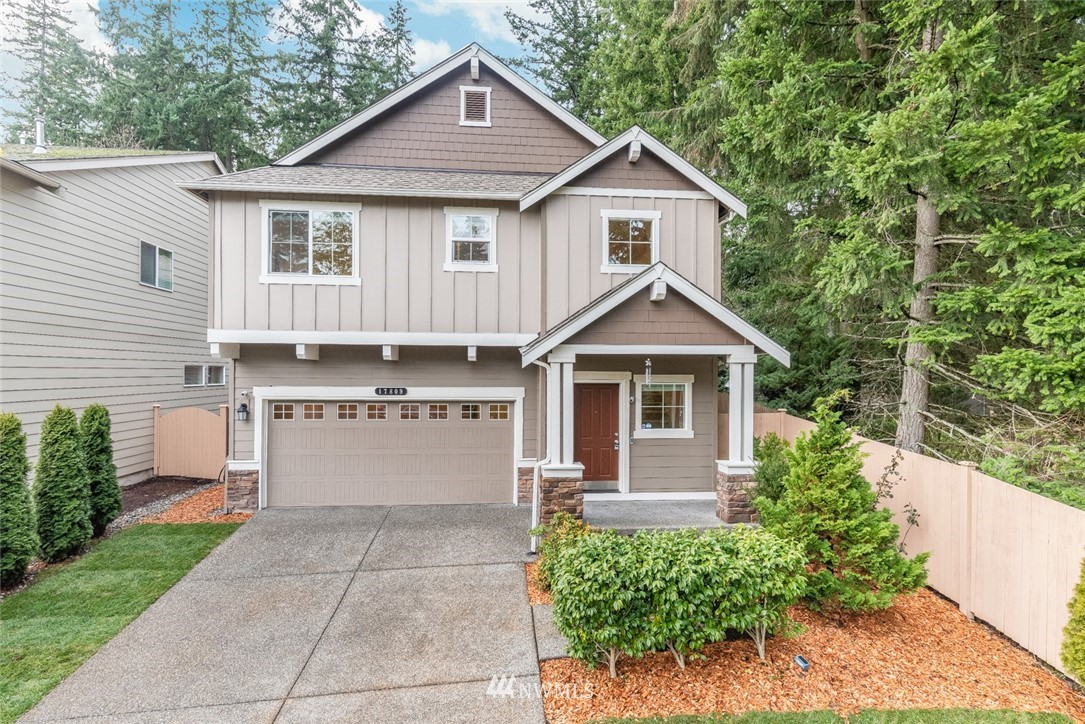 17809 46th Drive Southeast Bothell, WA 98012 - Photo 1 of 35 a view of a white house with a yard and potted plants