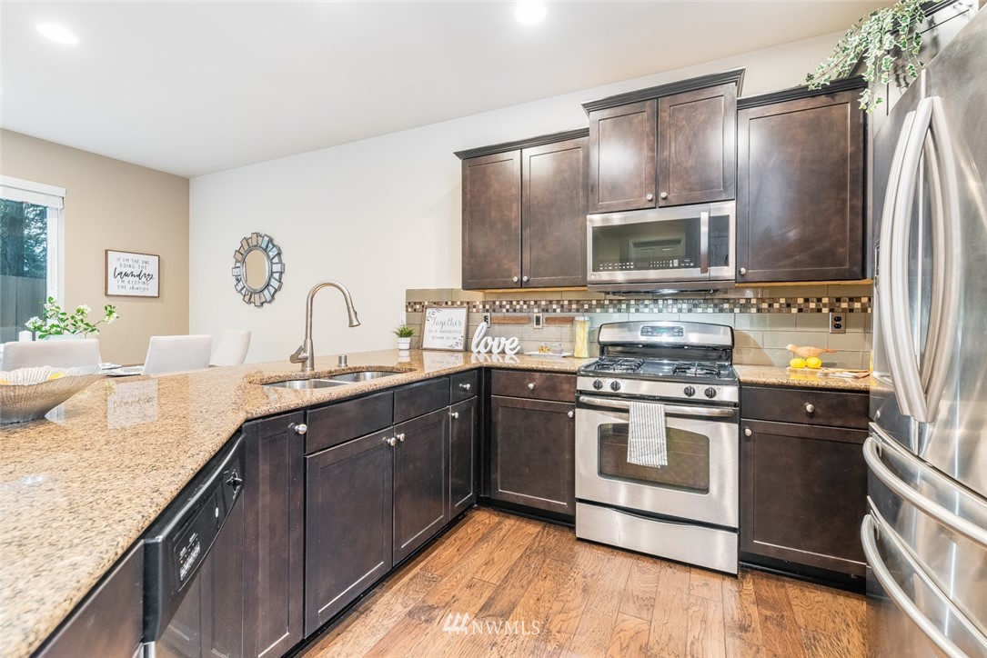 17809 46th Drive Southeast Bothell, WA 98012 - Photo 12 of 35 a kitchen with kitchen island granite countertop stainless steel appliances and sink