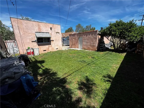 an aerial view of a house with a yard and a fountain