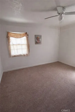 an empty room with wooden floor and door