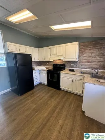 a kitchen with stainless steel appliances a stove a sink and a refrigerator