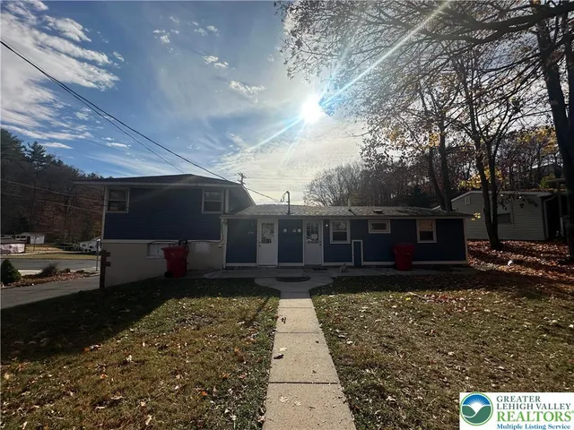 a view of house with yard outdoor seating