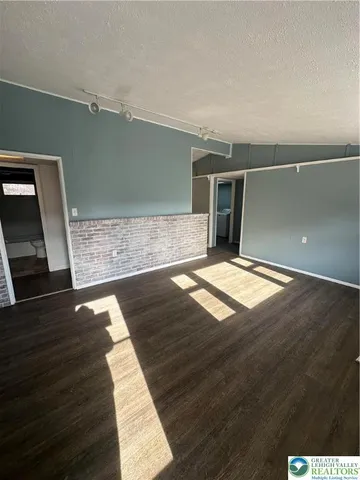 wooden floor in a hall with an empty room
