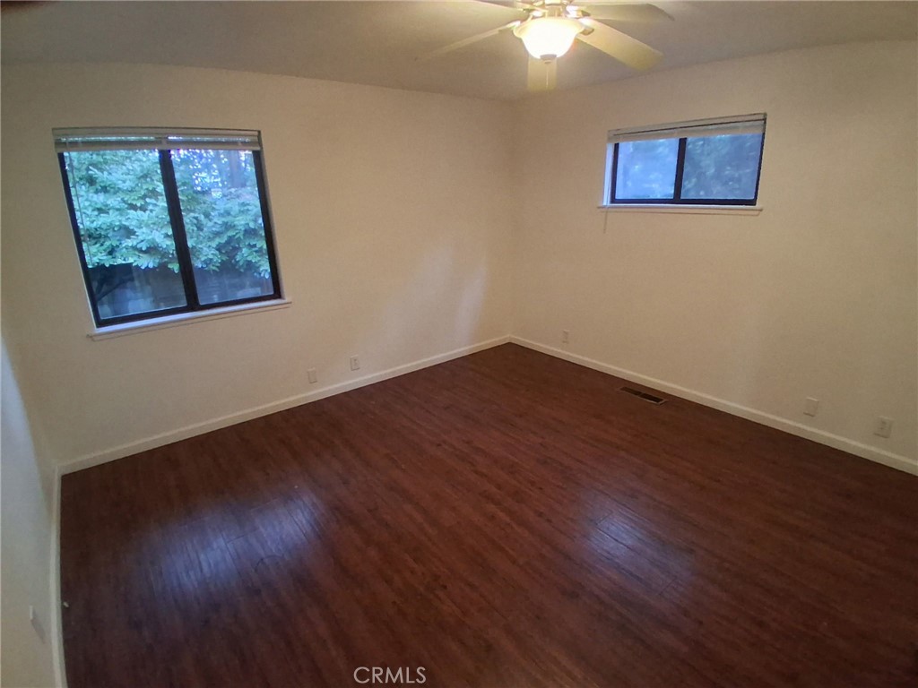 6402 Corning Court Magalia, CA 95954 - Photo 11 of 15 a view of an empty room with wooden floor and a fan