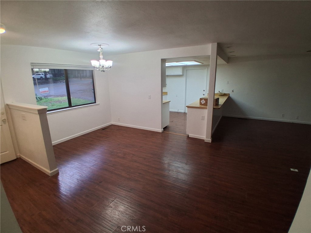 6402 Corning Court Magalia, CA 95954 - Photo 3 of 15 a view of an empty room with wooden floor and a window
