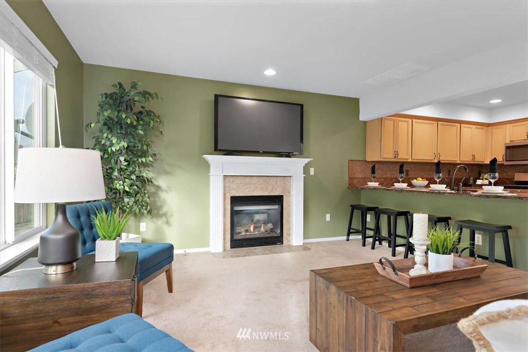18346 Rainier View Road Southeast Monroe, WA 98272 - Photo 12 of 40 a living room with furniture and a fireplace