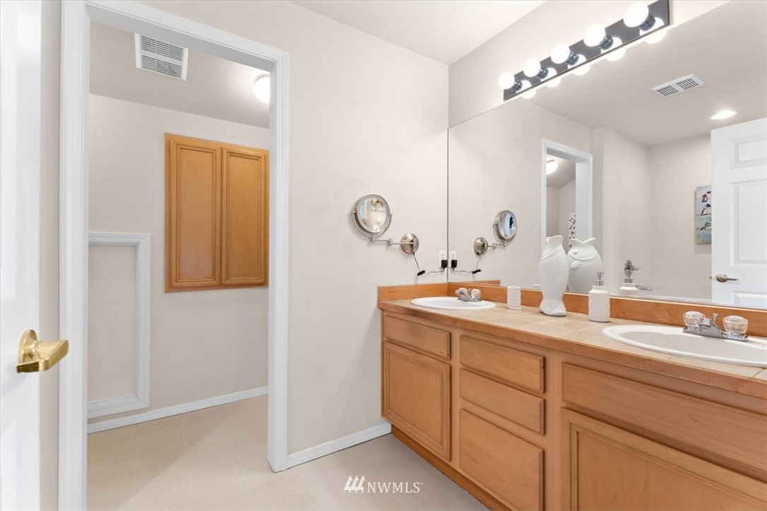 18346 Rainier View Road Southeast Monroe, WA 98272 - Photo 21 of 40 a bathroom with a double vanity sink and a mirror