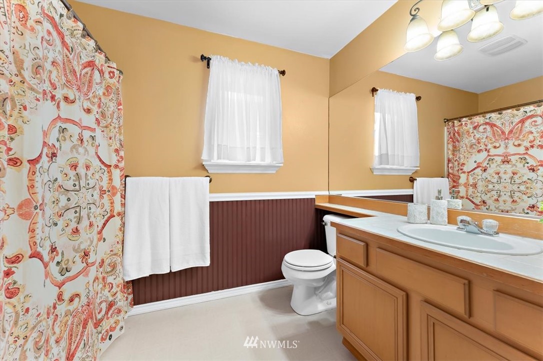 18346 Rainier View Road Southeast Monroe, WA 98272 - Photo 27 of 40 a bathroom with a sink toilet and shower
