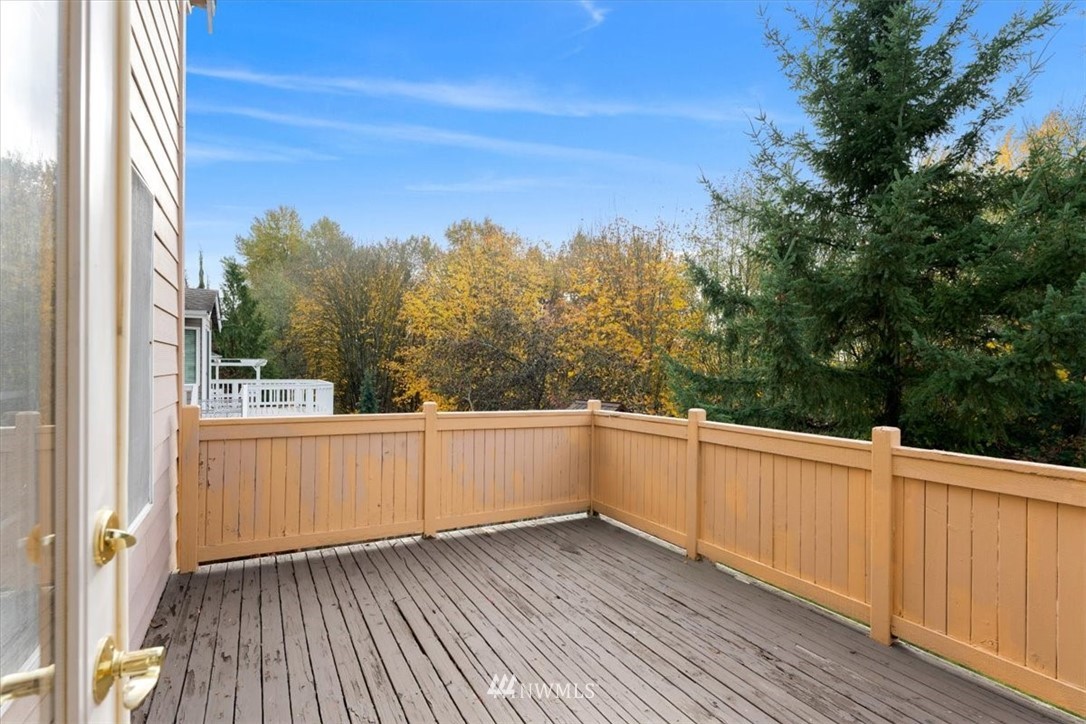 18346 Rainier View Road Southeast Monroe, WA 98272 - Photo 29 of 40 a view of a terrace with wooden floor and fence