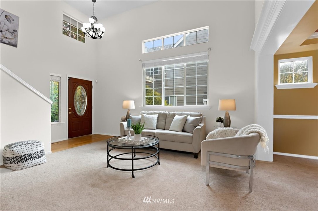 18346 Rainier View Road Southeast Monroe, WA 98272 - Photo 4 of 40 a living room with furniture a chandelier and a window