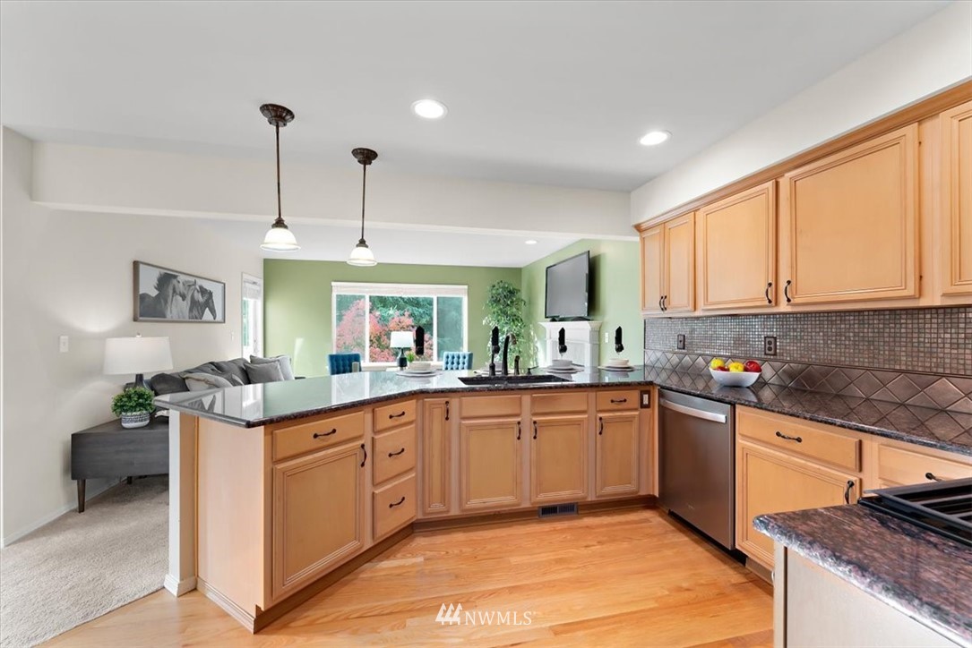 18346 Rainier View Road Southeast Monroe, WA 98272 - Photo 8 of 40 a kitchen with stainless steel appliances granite countertop a sink and stove