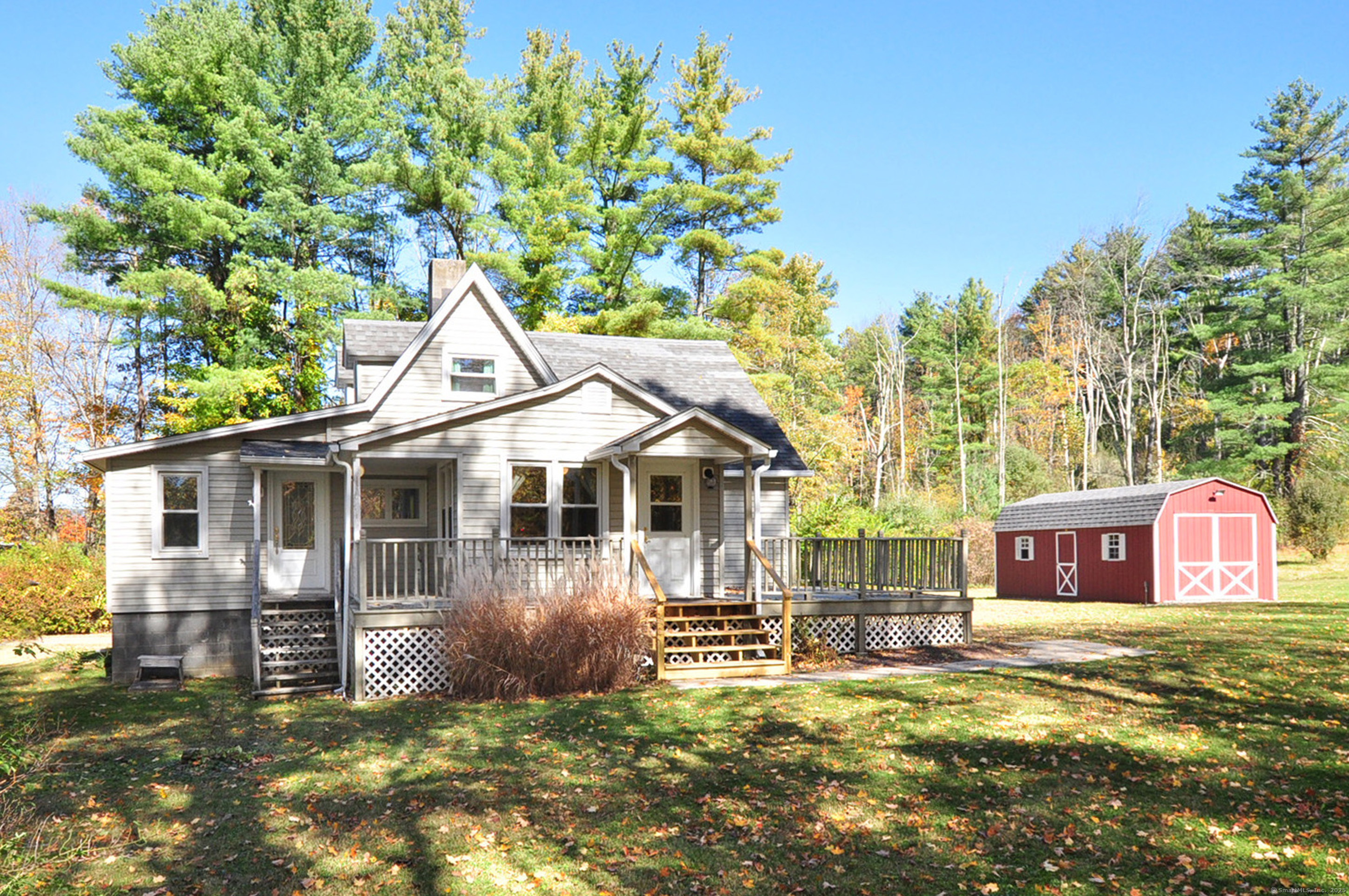 a view of a house with a yard patio and wooden fence
