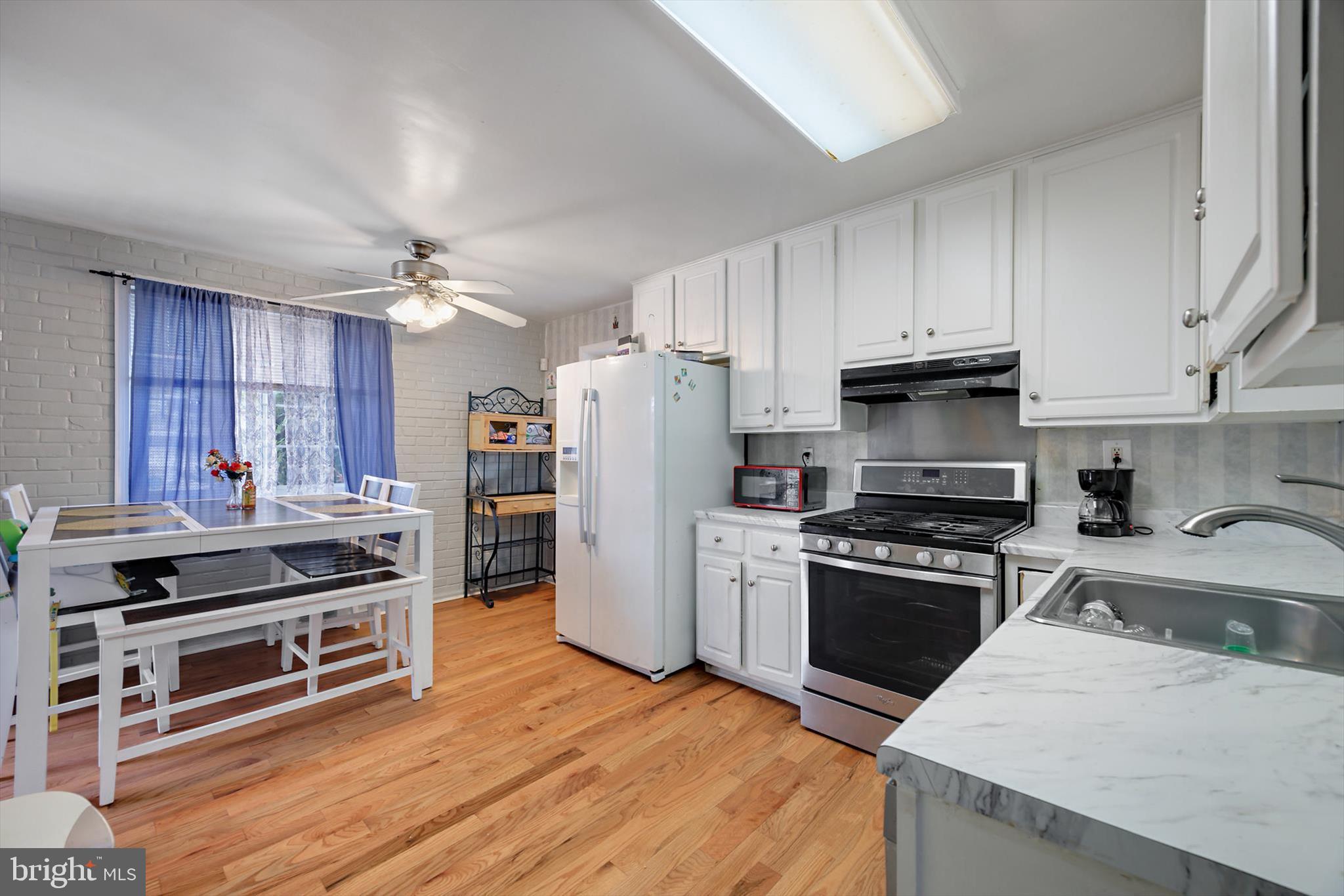 5401 Kenmont Road Oxon Hill, MD 20745 - Photo 1 of 39 a kitchen with stainless steel appliances a stove cabinets and wooden floor