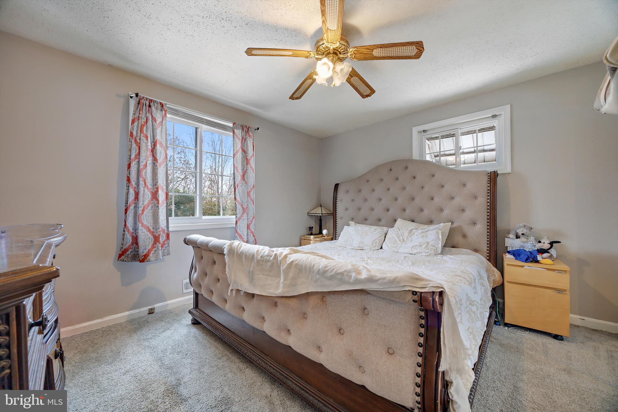 5401 Kenmont Road Oxon Hill, MD 20745 - Photo 15 of 39 a bedroom with a bed and a chandelier