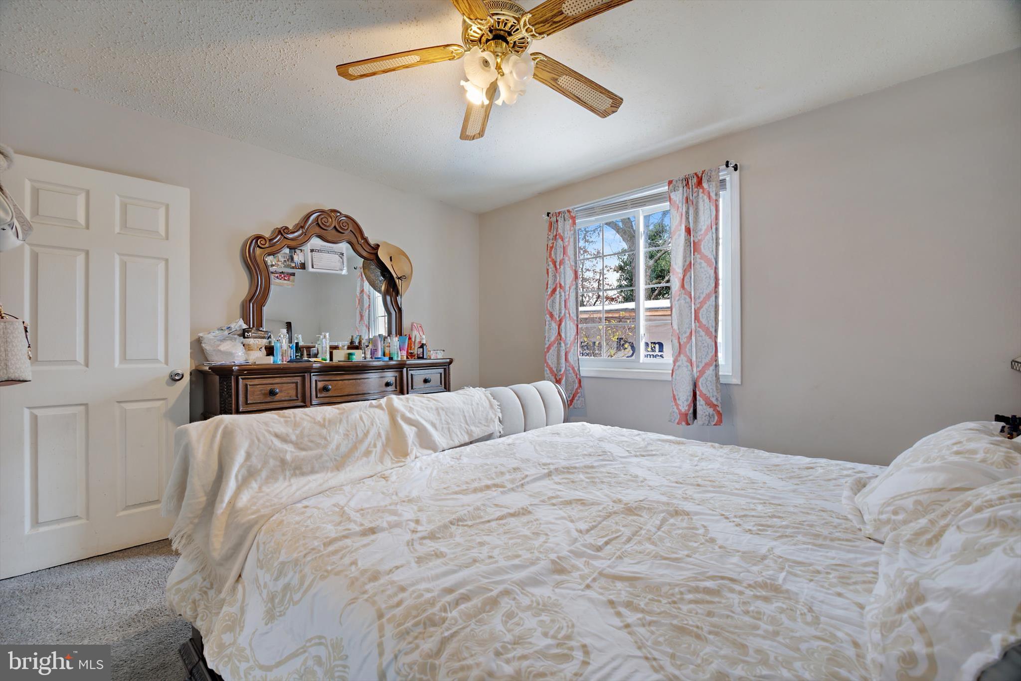 5401 Kenmont Road Oxon Hill, MD 20745 - Photo 16 of 39 a bedroom with a bed and a chandelier