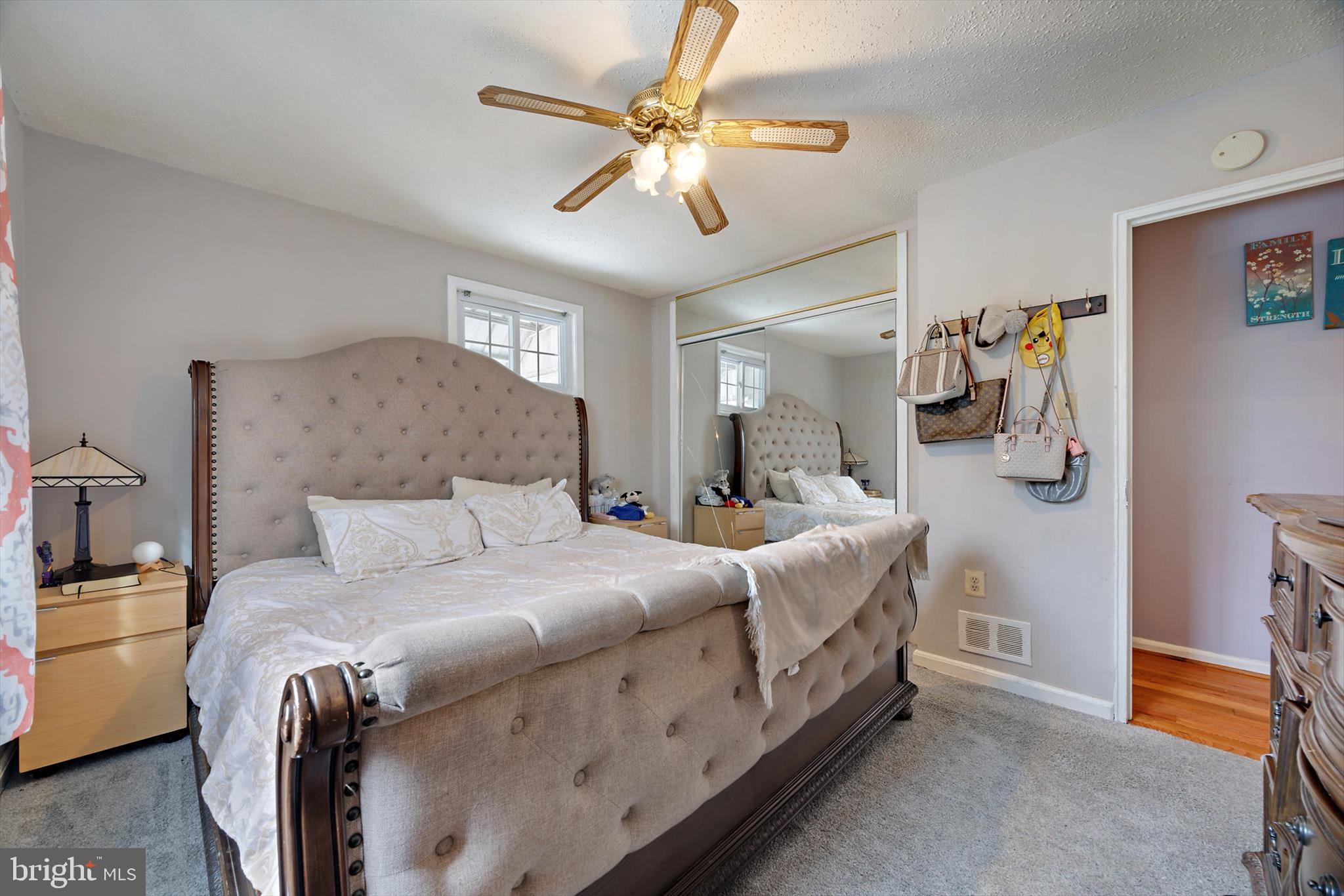 5401 Kenmont Road Oxon Hill, MD 20745 - Photo 17 of 39 a bed room with a bed and a chandelier