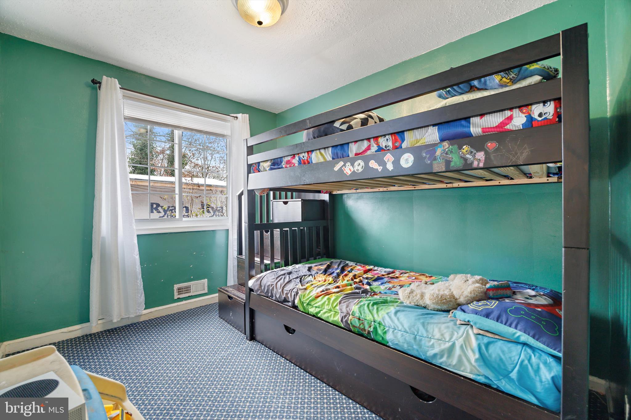 5401 Kenmont Road Oxon Hill, MD 20745 - Photo 21 of 39 a bedroom with bed and a window