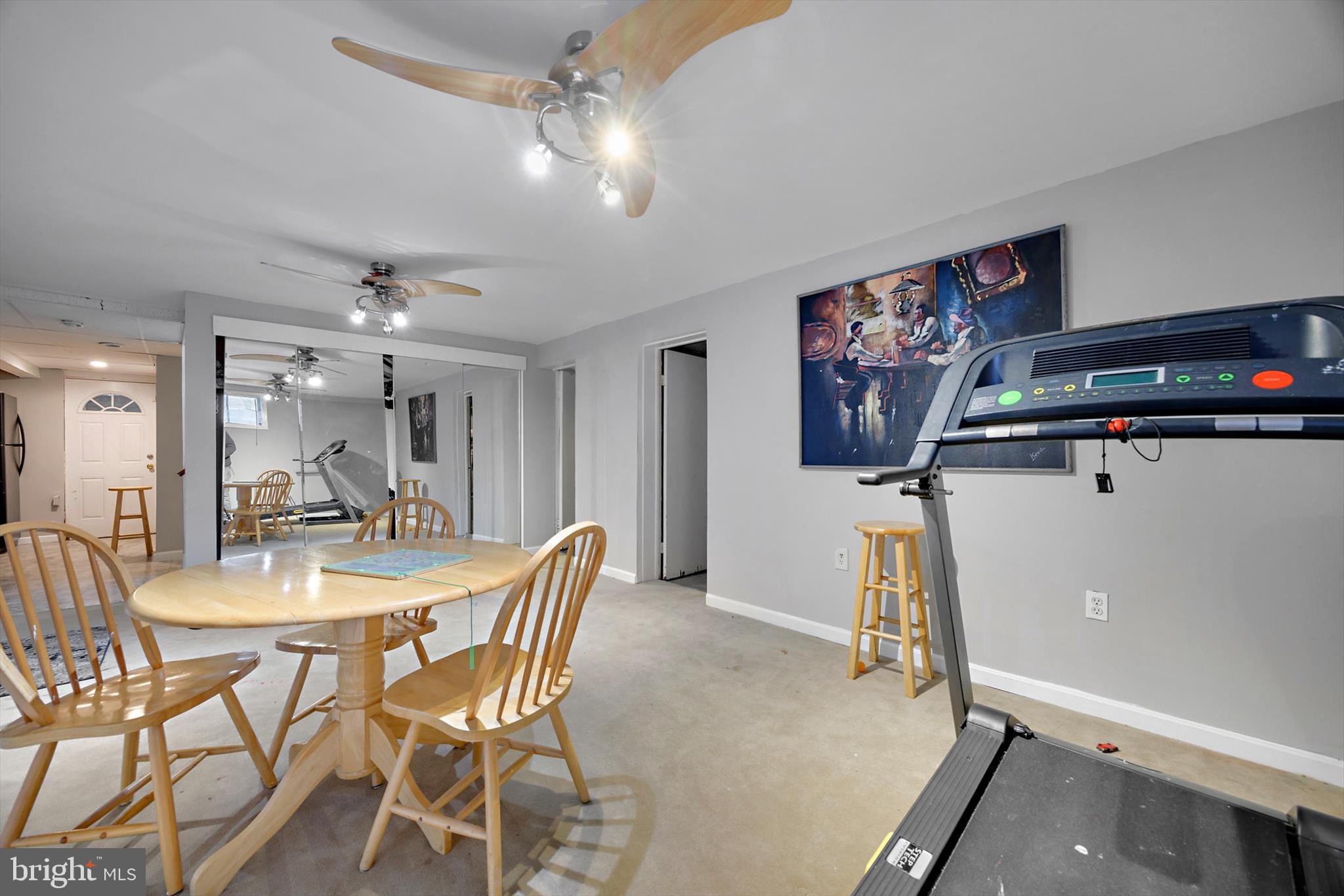 5401 Kenmont Road Oxon Hill, MD 20745 - Photo 28 of 39 a view of a dining room with furniture and a chandelier fan